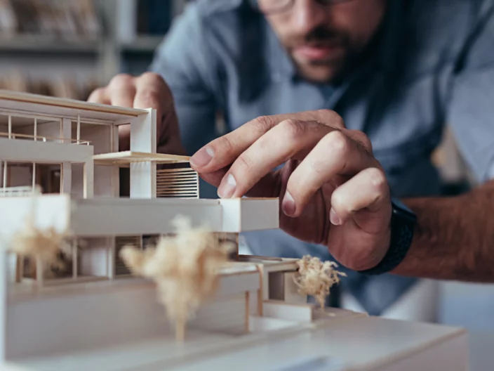 Architect hands making model house