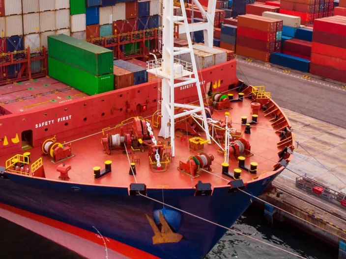 crane loanding cargo container to container ship in the international terminal yard port  concept freight shipping by ship at sunrise .