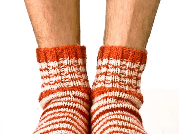 man legs in strip socks