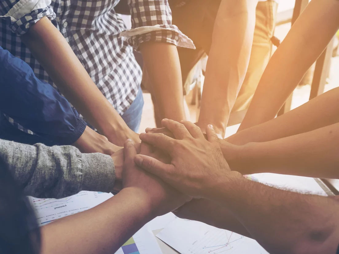 Business people join hand together during their meeting