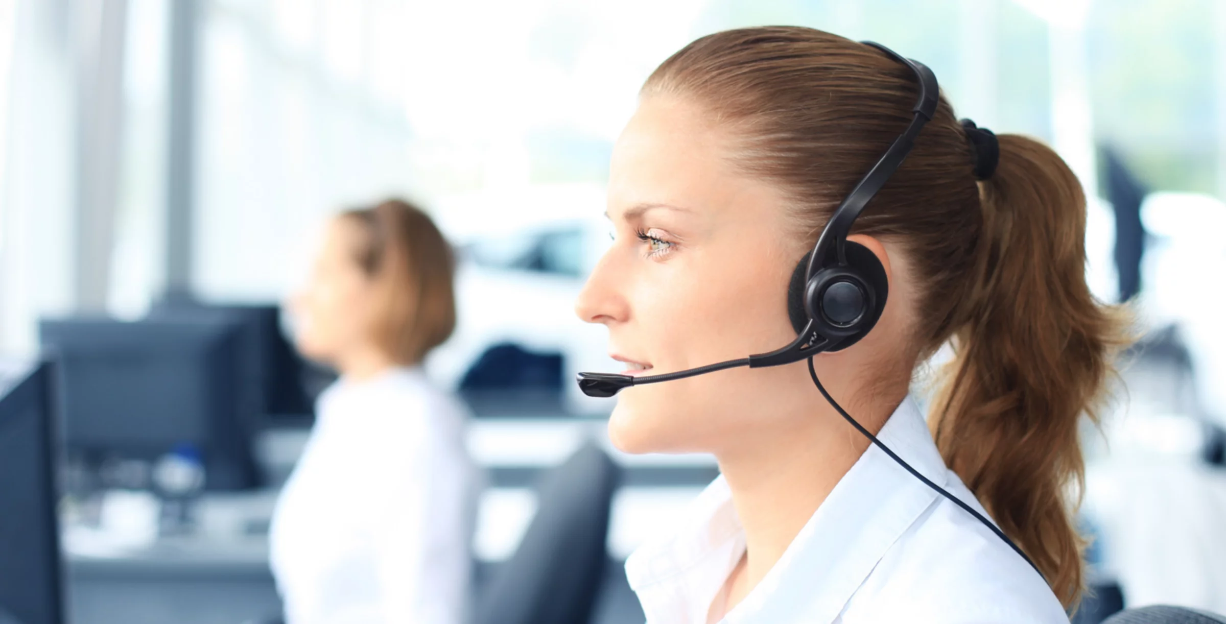 Beautiful young female call center operator with headset