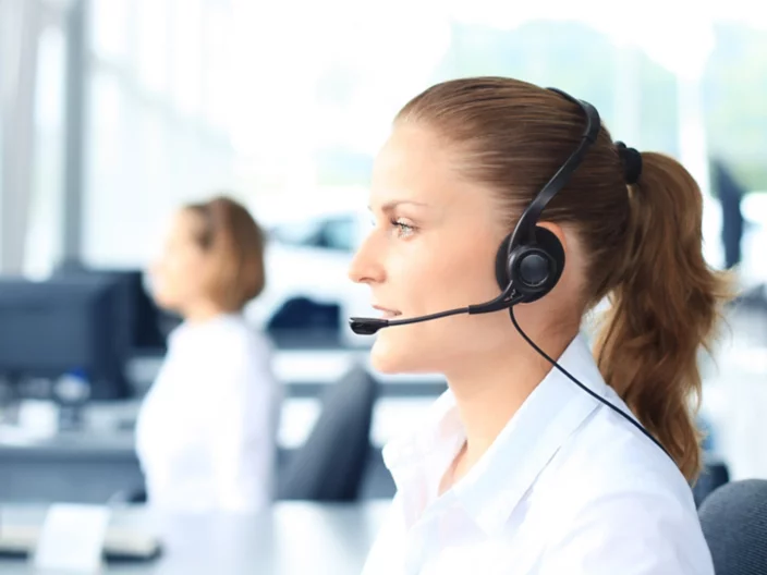 Beautiful young female call center operator with headset