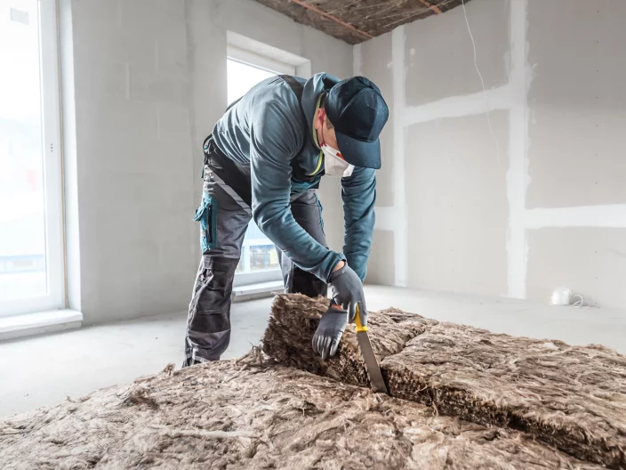 Cutting a thermal insulation from glass wool using a knife for stone wool