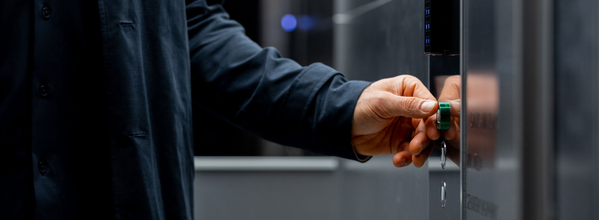 Man pressing green elevator button.