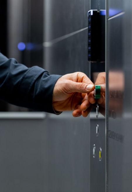 Man pressing green elevator button.