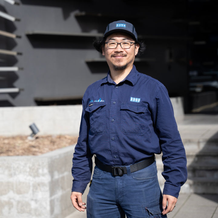 Bo Liu standing outside KONE Head Office in Auckland.