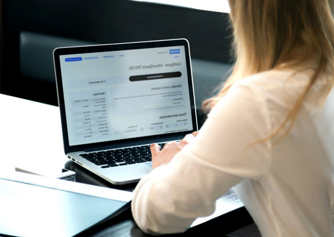 Woman working in front of laptop in an office.