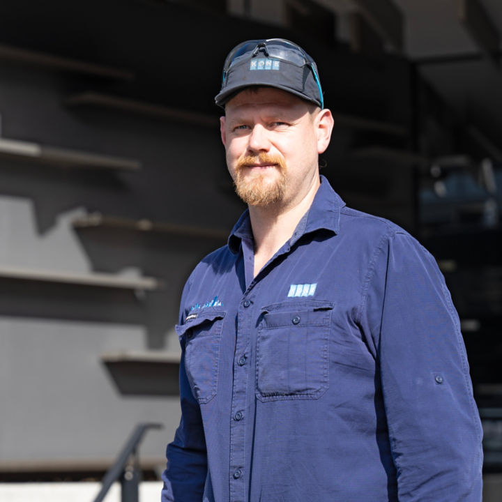 Christopher Platt standing outside KONE Head Office in Auckland.