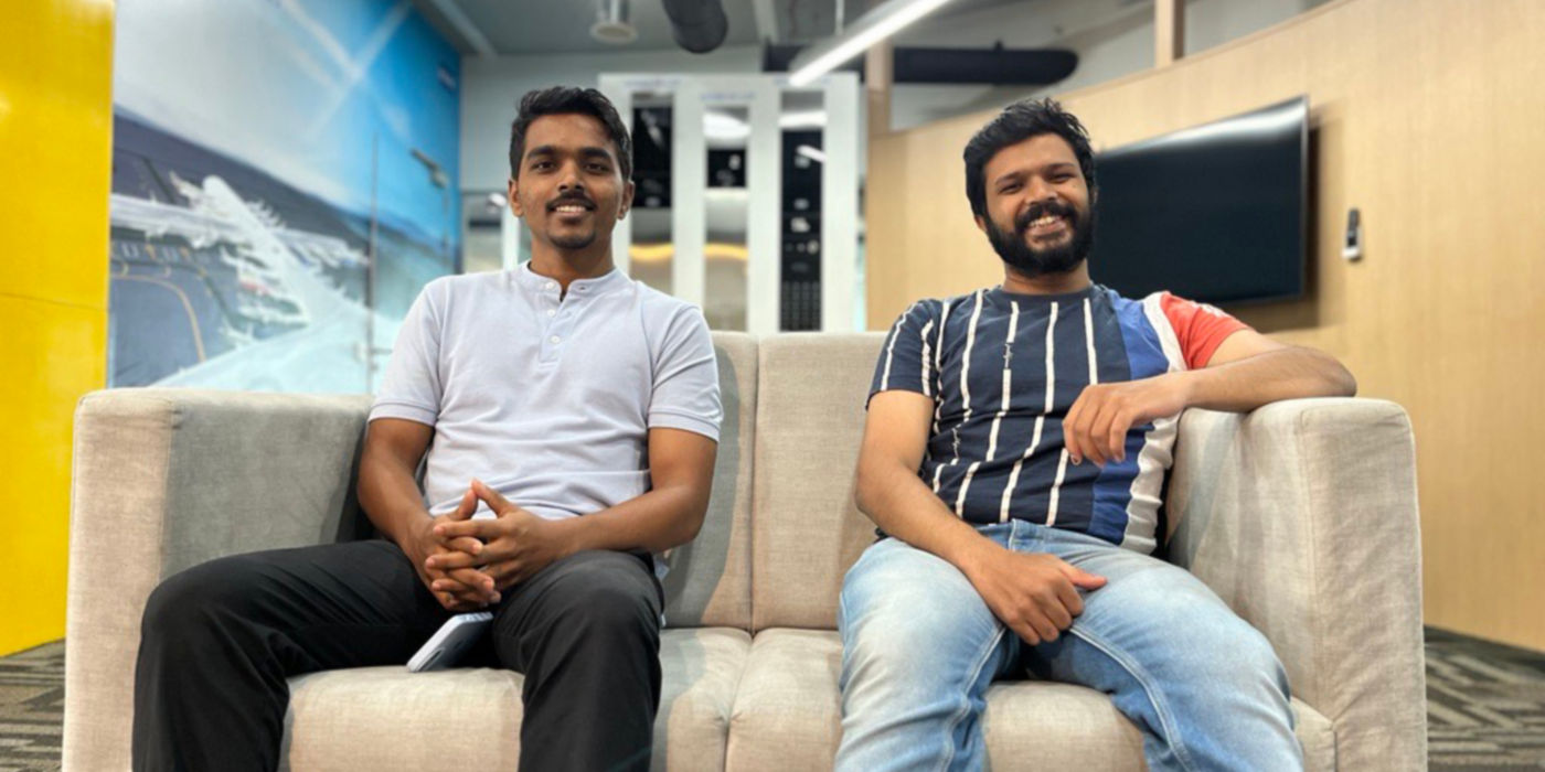 Rohit Jagadale and Aniket Kanthale sitting on an office sofa.