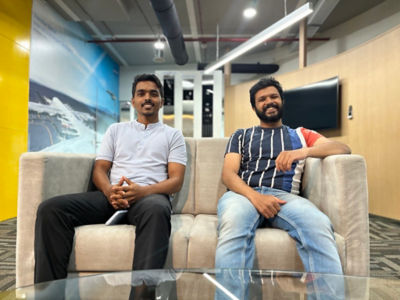 Rohit Jagadale and Aniket Kanthale sitting on an office sofa.