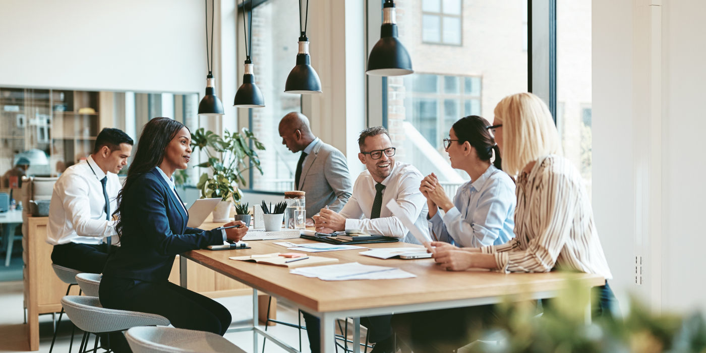 Group of people having a meeting around a table in a modern office.