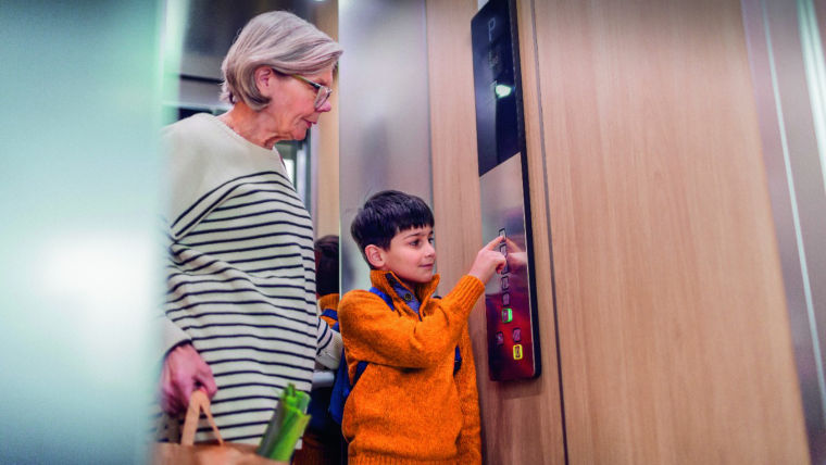Anciana y niño dentro de Elevador KONE