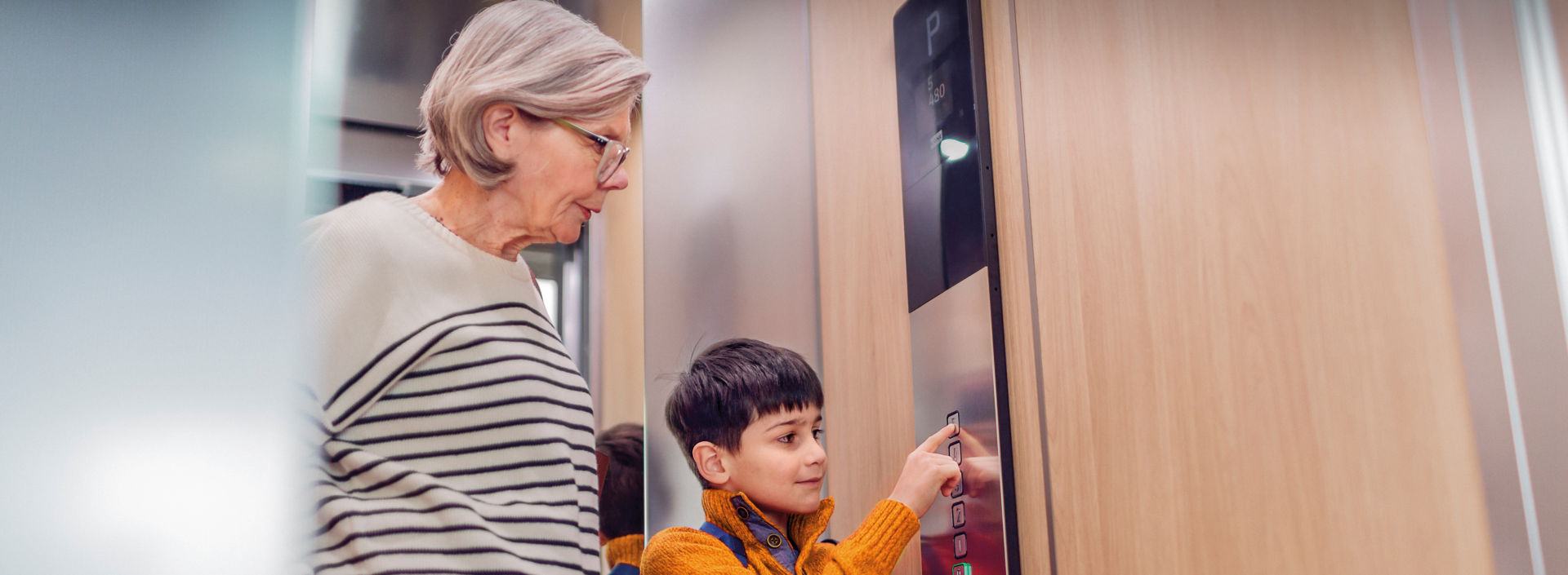 Elderly woman and boy KONE elevator