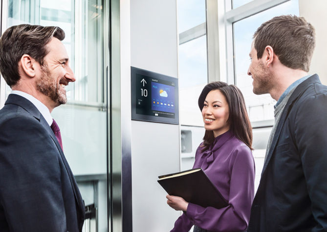 Businesspeople talking in an elevator