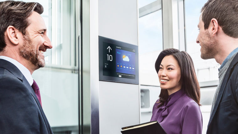 Businesspeople talking in an elevator