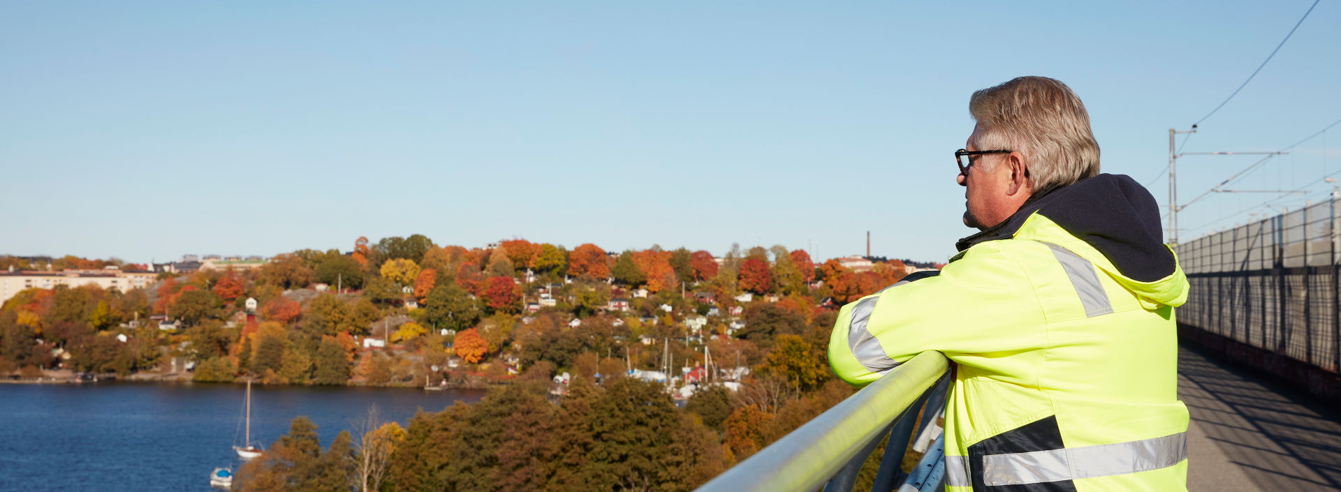 Stefan Wallin watching autumn view of Stockholm at bridge.