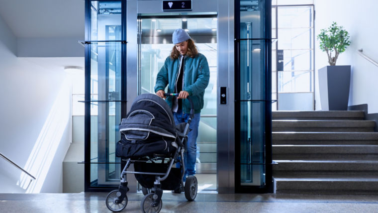 Person with stroller exiting an elevator.