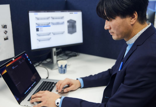 Man working in front of laptop in an office.