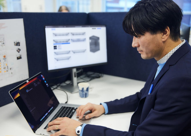 Man working in front of laptop in an office.