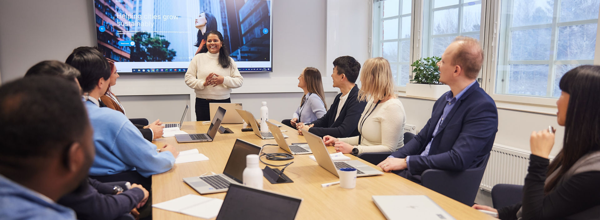Group of KONE employees having a meeting in conference room.