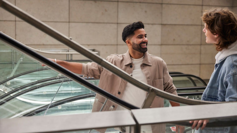 -Smiling men on escalator