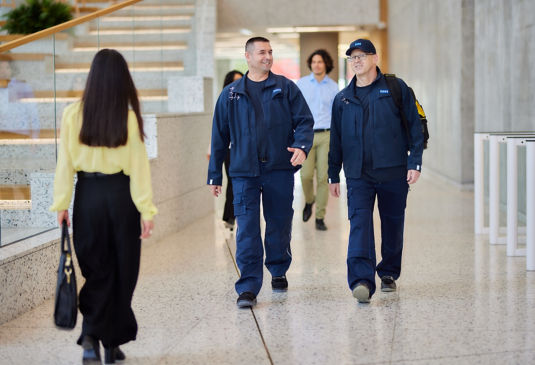 Two KONE technicians walking in office building.