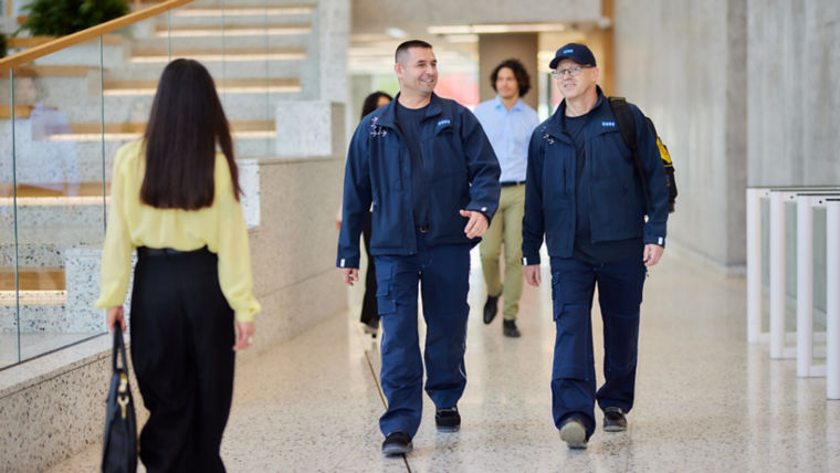Two KONE technicians walking in office building.
