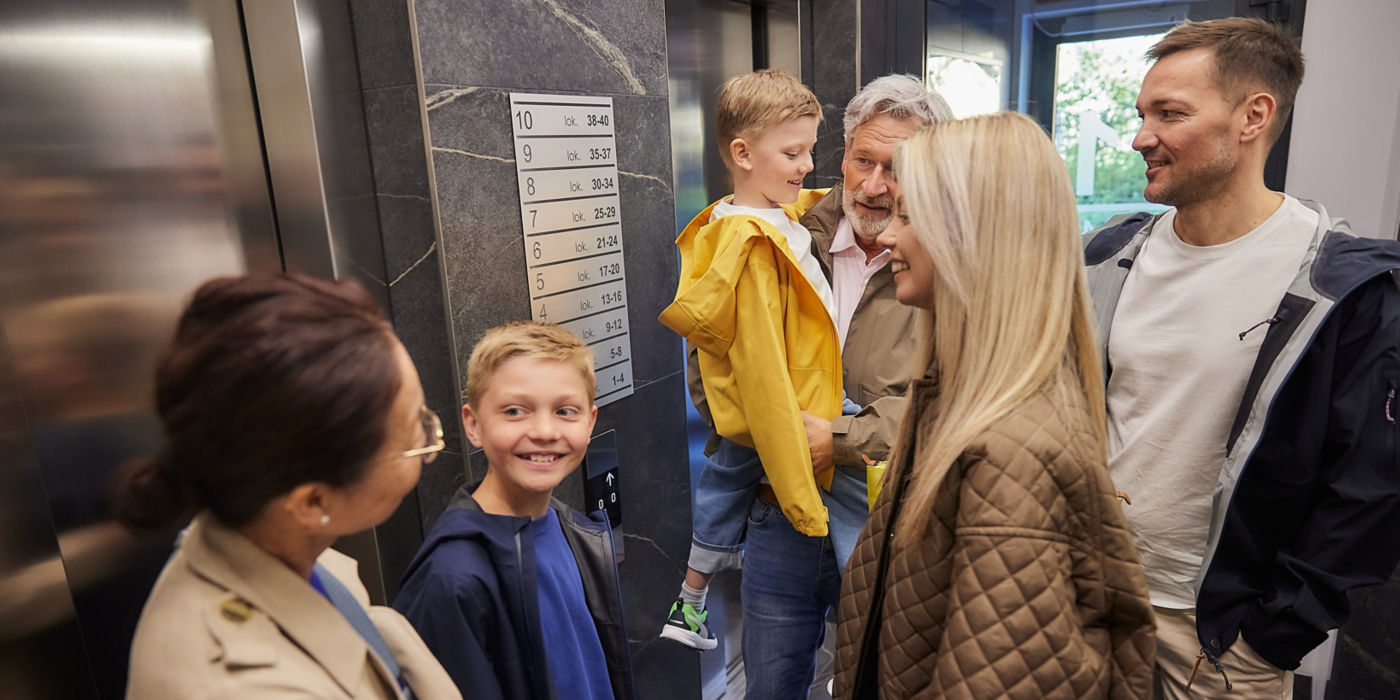 Family standing in front of an elevator.
