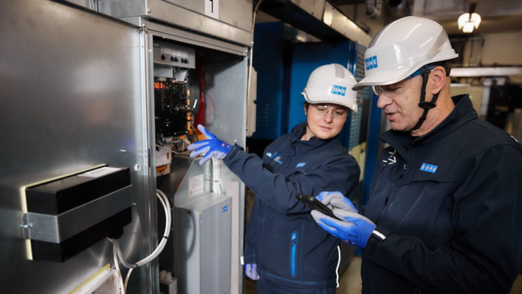 Two KONE technicians working together.