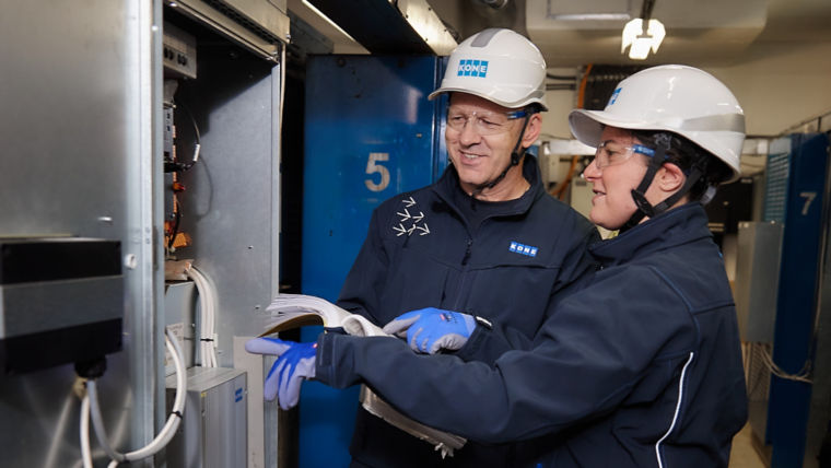 Two KONE technicians working together.