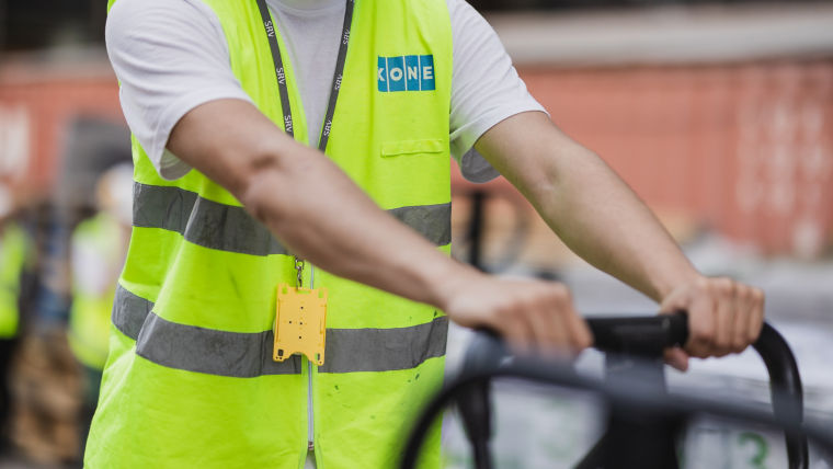 Construction site worker pushing cart.