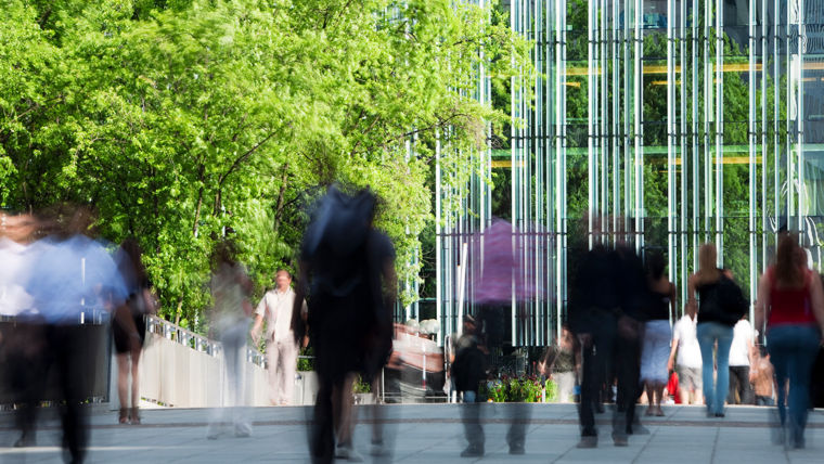 People moving around outside a building - KONE