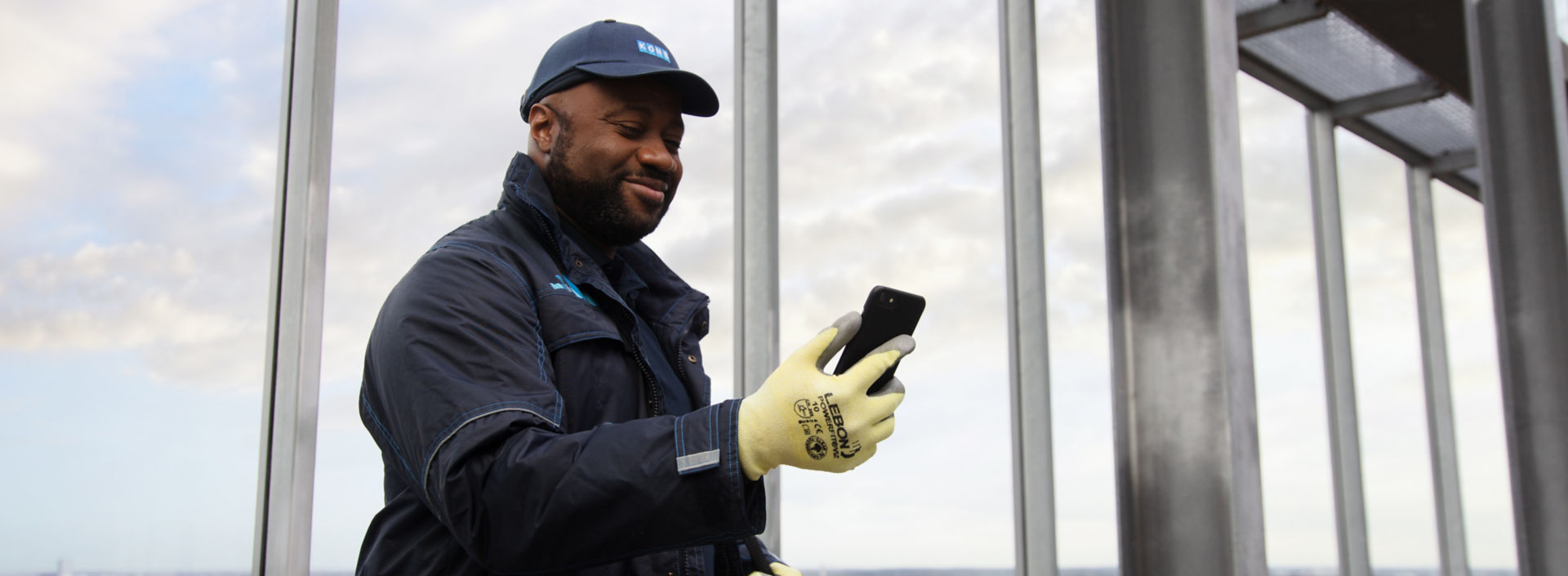 KONE technician looking at mobile phone