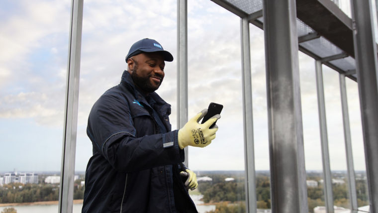 Maintenance technician man holding a phone - KONE