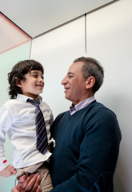 Man carrying a child while in elevator
