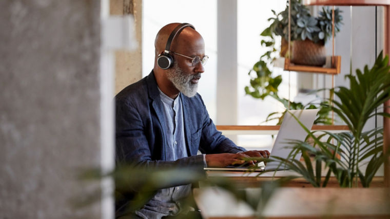 Man with headphones working on a computer - KONE Maintenance
