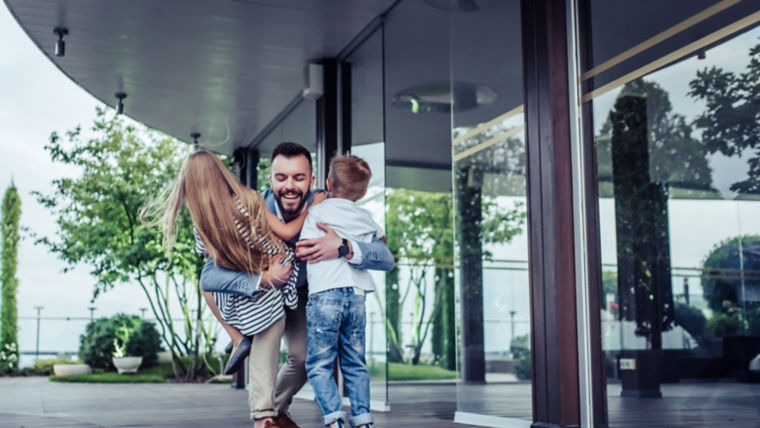 Man hugging children.