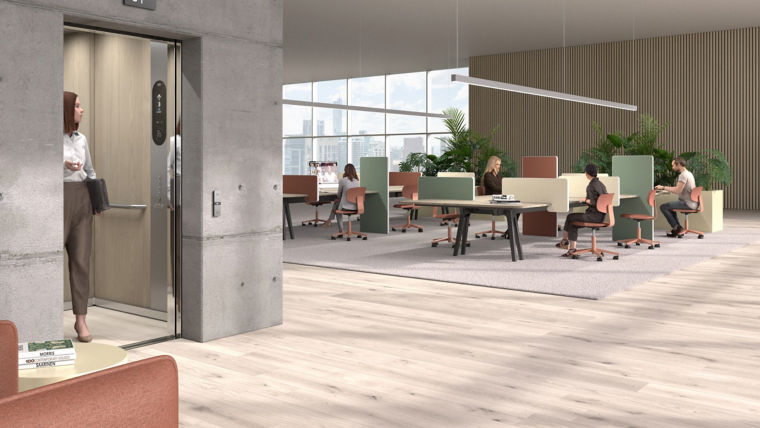 View of an office building floor where a woman is in elevator and people are working in front of desks.