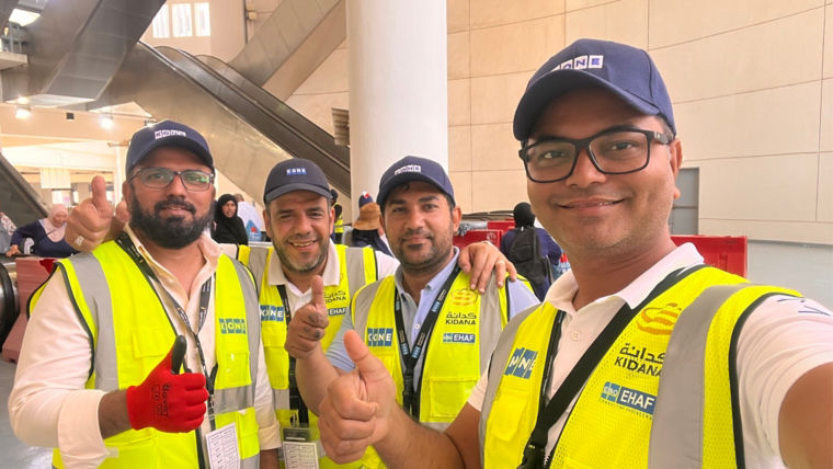 KONE Saudi team standing in near escalators