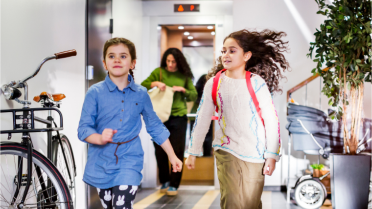 Kids running in a hallway from elevator - KONE Services