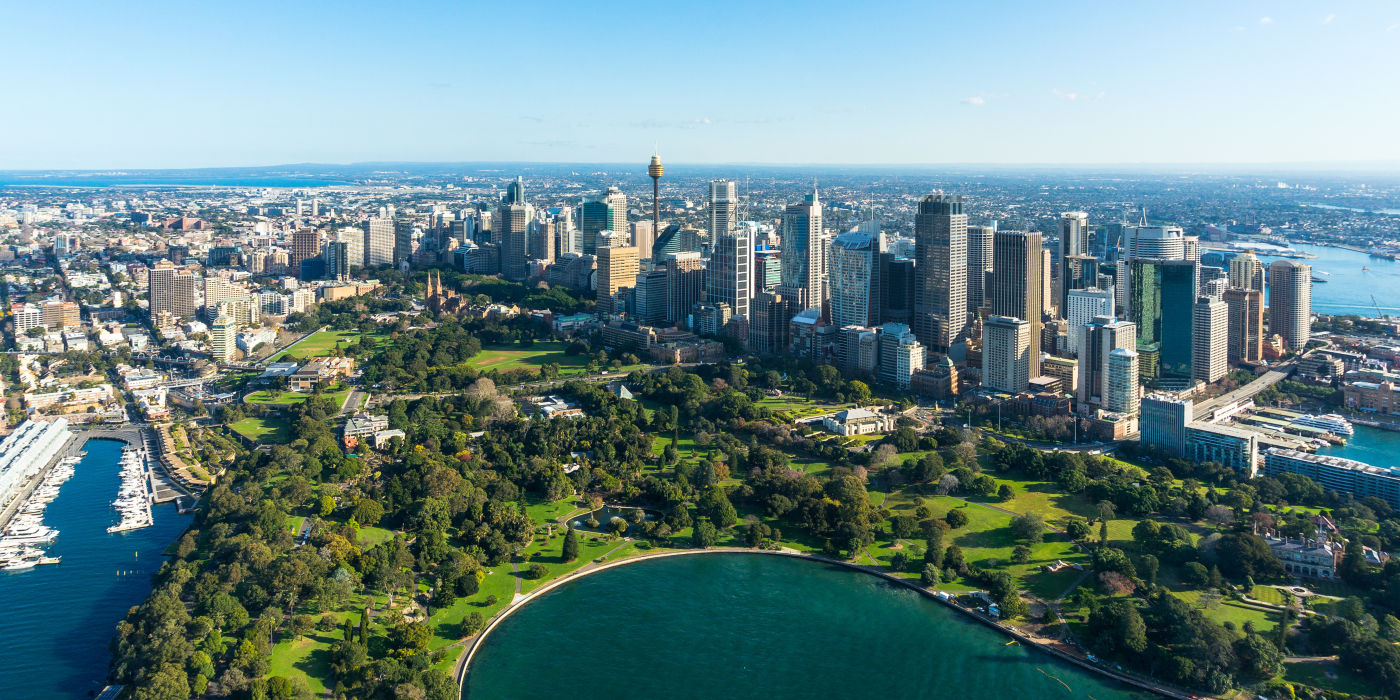 Aerial view of city with harbor and park.