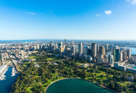 Aerial view of city with harbor and park.