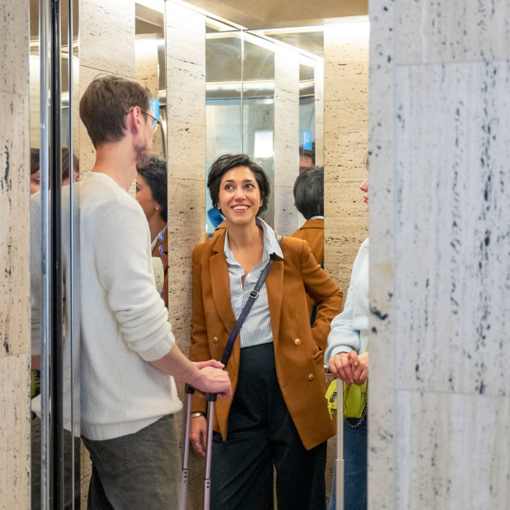 people_with_suitcases_in_elevator:720x720%281-1%29