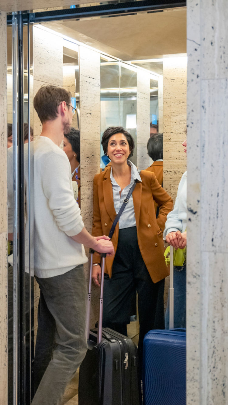 people_with_suitcases_in_elevator:750x1334