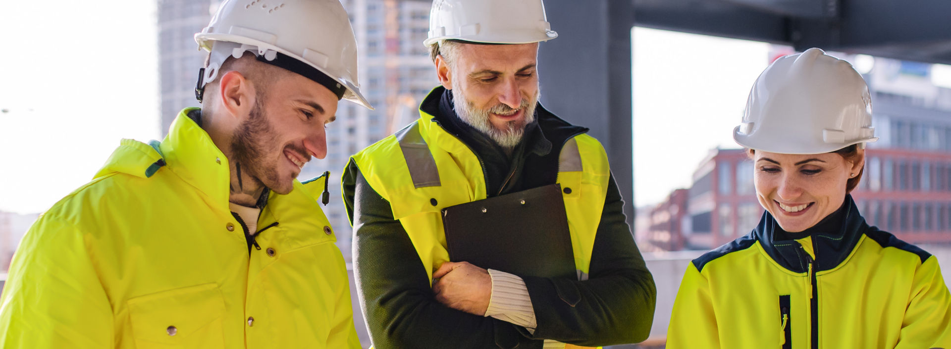 Group of engineers standing on construction site.