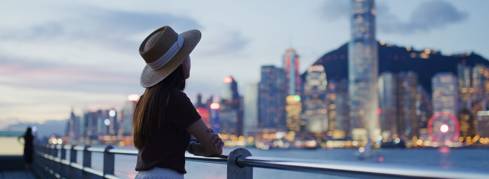 Woman enjoying the view of Hong Kong at night.