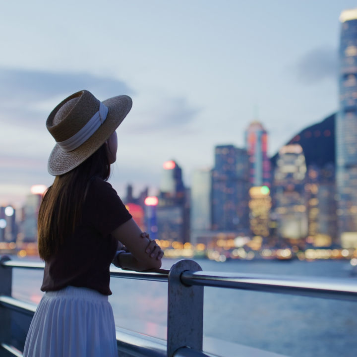 Woman enjoying the view of Hong Kong at night.