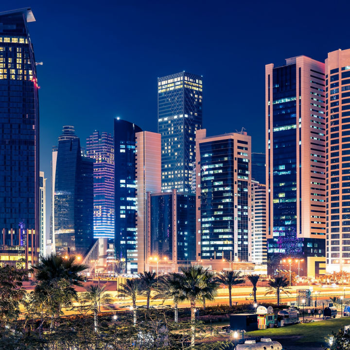 Night view in the city center of Doha with modern buildings and city lights.