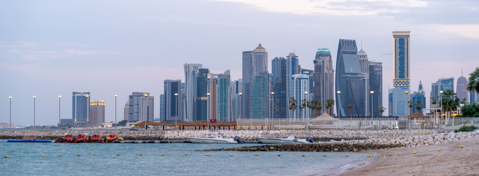 Doha seaside and skyline with many offices and residential towers.