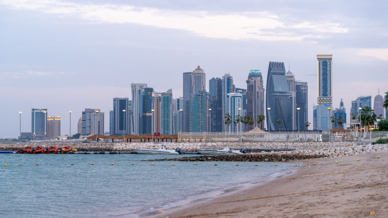 Doha seaside and skyline with many offices and residential towers.